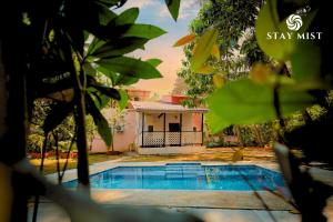 a house with a swimming pool in front of it at Pearl Castle Villa I Staymist in Nagaon