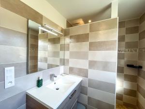 a bathroom with a sink and a mirror at Maison Lévi avec vue mer et à 200m du port in Digosville +26 photos