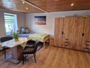 a room with a bed and a wooden cabinet at Wieprecht`s Vermietung in Deutsches Haus