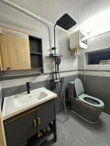 a small bathroom with a sink and a toilet at DK2 Homestay in Hanoi