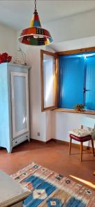 a living room with a table and a pendant light at La Porta Azzurra 