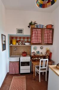 a kitchen with a stove and a table in it at La Porta Azzurra 