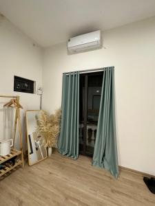 a room with a window with green curtains at DK2 Homestay in Hanoi +5 photos