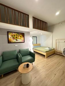 a living room with a couch and a bed at DK2 Homestay in Hanoi