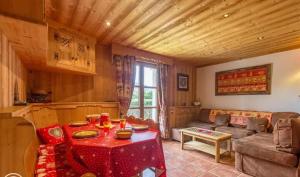 a living room with a couch and a table at Appartement confortable à Megève | 46m² | Vue sur montagne in Megève