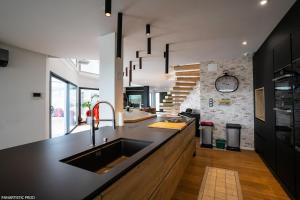 a kitchen with a sink and a counter top at Villa "Colmar" Spa and Free vine test in Raedersheim