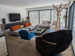 a living room with a couch and a chair at Villa "Colmar" Spa and Free vine test in Raedersheim