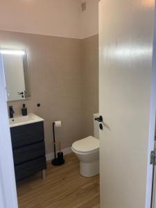 a bathroom with a white toilet and a sink at Sea La Vie Apartment Porto Santo in Porto Santo +15 photos