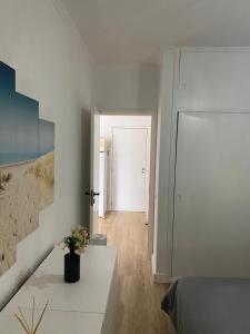 a white room with a bed and a hallway at Sea La Vie Apartment Porto Santo in Porto Santo