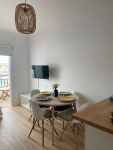 a kitchen and dining room with a table and chairs at Sea La Vie Apartment Porto Santo in Porto Santo