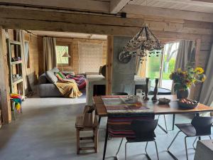 a living room with a table and a couch at Dom w sadzie  +23 photos