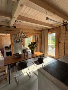a dining room with a wooden table and chairs at Dom w sadzie 