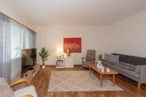 a living room with a couch and a table at Apartment LA Invest in Rovaniemi