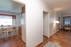 a living room with a table and a dining room at Apartment LA Invest in Rovaniemi