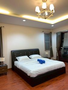 a bedroom with a large bed with a blue towel on it at The Horizon Villa Songkhla in Ban Mai