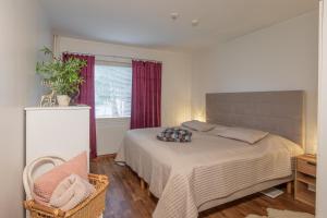 a bedroom with a bed and a chair and a window at Apartment LA Invest in Rovaniemi