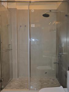 a shower with a glass door in a bathroom at Mundoota House in Jaipur +24 photos