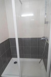 a shower with a glass door in a bathroom at Gite du mazel in Naussac +12 photos