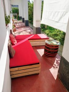 a porch with three beds on a patio at Szelíd Tisza Vályog Vendégház Tiszafüred in Tiszafüred
