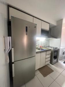 a kitchen with a stainless steel refrigerator and appliances at Próx a praia in São Luís