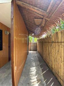 a hallway of a house with a wooden wall at Honu Homestay Siargao in Sampong