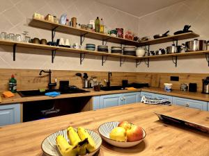 a kitchen with two bowls of fruit on a wooden table at Posada de la Luna in Granada +31 photos