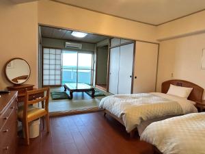 a bedroom with two beds and a desk and a mirror at Went Members only Resort Condominium in Sumoto +41 photos