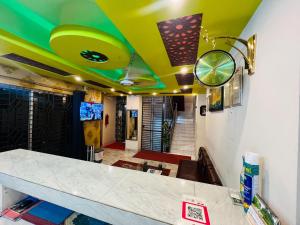 a restaurant with a yellow ceiling and a counter at Hotel Inn Chittagong in Chittagong +82 photos