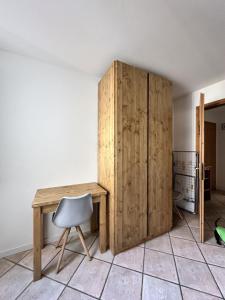 a desk and a chair next to a wooden cabinet at Il Mulino - Bilocale in centro in Ponte di Legno