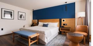 a bedroom with a large bed with a blue headboard at voco Ciudad de Mexico Reforma by IHG in Mexico City +35 photos