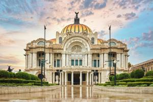 a large building with a statue on top of it at voco Ciudad de Mexico Reforma by IHG in Mexico City