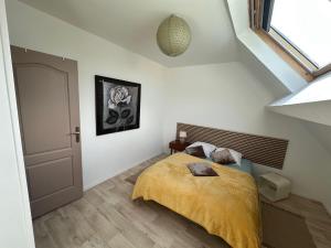 1 dormitorio con 1 cama con manta amarilla en villa Maopi, en Wimereux