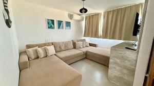 a living room with a couch and a table at Casa Oxente - 2da praia condominio com piscina in Cayru