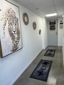 a hallway with two rugs on the floor and a picture of a leopard at Studio, quiet and secure in ZA in Chaingy