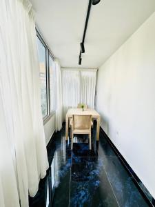 a dining room with a table and a window at ROOMES NILE VIEW MANIEl in Cairo