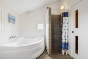 a white bathroom with a tub and a shower at LN2020-Hjorring-Fjorden-2 in Lønstrup +14 photos