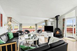 a living room with a couch and a fireplace at LN2020-Hjorring-Fjorden-2 in Lønstrup