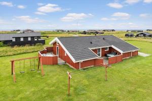 a small house with a playground in a field at LN2020-Hjorring-Fjorden-2 in Lønstrup