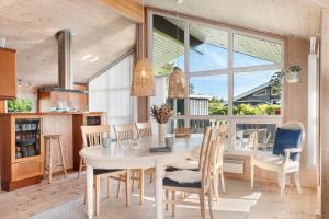 a kitchen and dining room with a table and chairs at HA385-Hals-Sonder-Havsig-8 in Hou