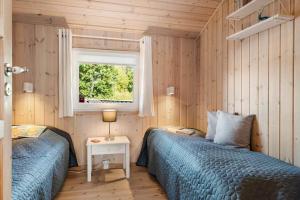 a bedroom with two beds and a window at HA385-Hals-Sonder-Havsig-8 in Hou
