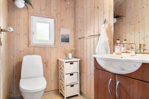 a bathroom with a toilet and a sink at HA385-Hals-Sonder-Havsig-8 in Hou +27 photos