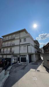 a white building with a parking lot in front of it at Borgo Trento Residence - Vista Monte Grappa in Verona +5 photos