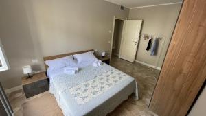 a bedroom with a bed with white sheets and pillows at Borgo Trento Residence - Vista Monte Grappa in Verona