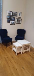 a living room with two chairs and a table at Poznań old city studio in Poznań