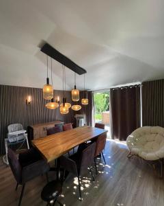 a dining room with a wooden table and chairs at Maison familiale au calme in Saint-Félix