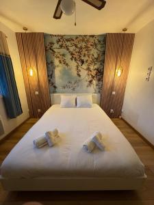 a bedroom with a bed with two bow ties on it at Maison familiale au calme in Saint-Félix +19 photos