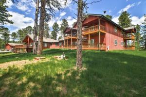 a large red barn with trees in front of it at Deadwood SD 11k sq ft 9 Bd Suites 11 Ba Sleeps 35 Plus in Deadwood