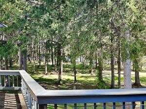 a wooden deck with trees in the background at Arrowhead Village 13 in Thayerville