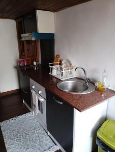 a kitchen with a sink and a counter top at Petite maison meublée in Saint-André