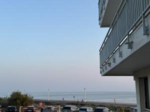 a parking lot next to a beach with cars parked at Appartement d'architecte face à la mer in Les Sables-dʼOlonne